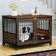 a dog is sitting in his crate under the stairs