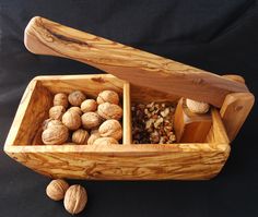 a wooden box filled with nuts on top of a table