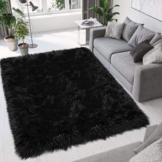 a living room filled with furniture and a black rug