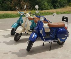 two scooters parked next to each other on the street