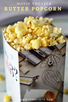 a popcorn box filled with yellow popcorn on top of a table