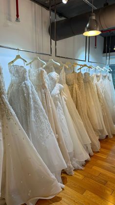 there are many dresses on display in the store, all lined up and ready to be sold