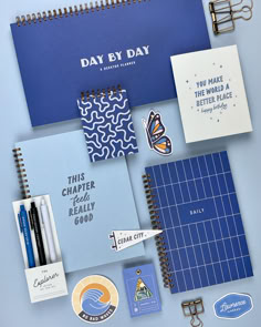 A collection of blue notebooks, pens, stickers, and other stationery items. Cute Agenda Ideas, Planner Book Design, Gift Shop Design, Stationery Flatlay, Got Stickers, Stationary Design Inspiration, Notebooks Design, Stationery Photography, Notepad Design