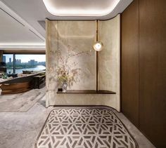 an elegant bathroom with marble walls and flooring, along with a large mirror on the wall