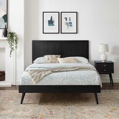 a bedroom with a bed, nightstands and two pictures on the wall above it