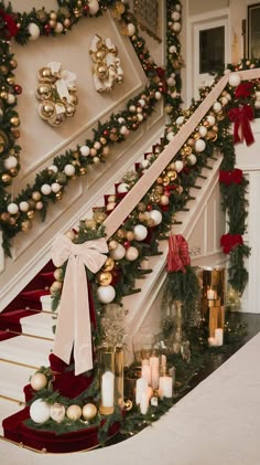 a staircase decorated with christmas decorations and candles