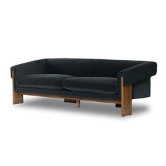 a black couch sitting on top of a wooden frame