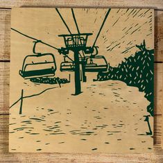 a wooden coaster with a drawing of a ski lift