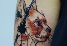 a cat tattoo on the left arm