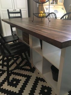 a kitchen table with two chairs next to it