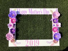 a mother's day photo frame with flowers on the grass in front of it