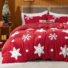 a bed with red and white snowflakes on it