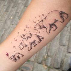 a bear and cub tattoo on the left arm, with stars in the sky above it