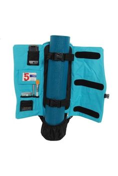 an overhead view of a blue life jacket with various items attached to the back pocket