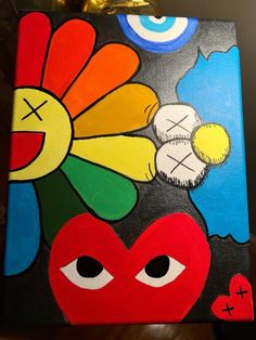 a colorful painting with eyes and flowers on it