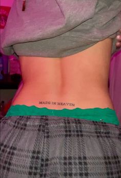 the back of a woman's stomach with words written on her lower back and bottom