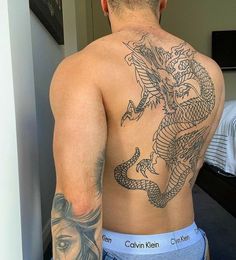 a man with a dragon tattoo on his back