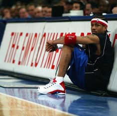 a basketball player sitting on the floor with his headbands in place to rest