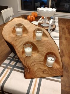 a wooden tray with candles on top of it