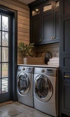 a washer and dryer sitting in front of a window next to a door