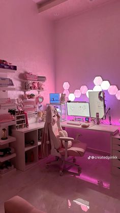 a room with pink lighting and lots of shelves on the wall, along with a computer desk