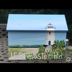 a small box with a lighthouse painted on it