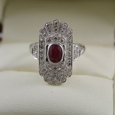 FABULOUS ANTIQUE ART DECO STYLE RING COMES WITH RECENT VALUATION RETAIL CERTIFICATE HAND MADE ART DECO STYLE RING THIS GORGEOUS RING IS SET Anniversary Ruby Ring In White Gold With Diamond Accents, Anniversary White Gold Ruby Ring With Diamond Accents, Platinum White Gold Rings With Gemstone, Art Deco Ring In Diamond White With Jewels, Vintage Platinum Ring With Gemstone, Exquisite Hallmarked Cluster Ring For Anniversary, Platinum Cluster Ring Hallmarked For Gift, Art Deco White Gold Gemstone Ring, Wedding Ruby Ring In White Gold With Diamond Accents