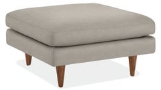 the footstool is made out of fabric and wooden legs, with a light gray color