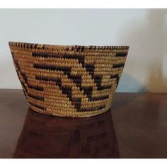 a woven basket sitting on top of a wooden table