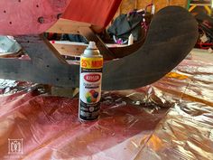 a bottle of glue sitting on top of a piece of wood next to a sled