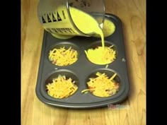 a person pouring cheese into muffin tins