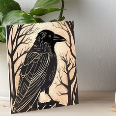 a black crow sitting on top of a tree branch art board print by person in front of white wall