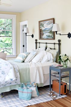 a bed sitting in a bedroom next to a window