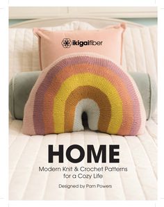 the front cover of a knitted pillow with an image of a rainbow on it