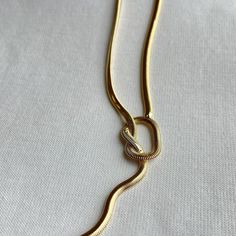 This Angela Knot Necklace will give your look a modern edge! Crafted with a snake chain, it's the perfect piece to add a little twist to your wardrobe. 13.5" + 3" Ext. 18k Gold Plated Over Stainless Steel Hypoallergenic Water & Tarnish Resistant A Snake, Knot Necklace, Signature Scent, Original Gift, Pillow Pattern, Cz Stone, Snake Chain, Jewelry Care, Sale Items