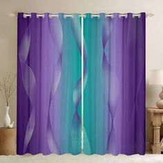 a purple and blue curtain hanging on the side of a window in a living room