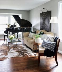 a living room filled with furniture and a grand piano