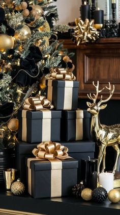 a christmas tree is decorated with black and gold wrapped presents, deer figurines and candles