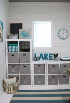 a room with white walls and gray drawers