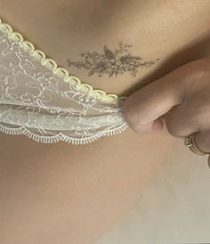 a close up of a woman's stomach with tattoos on her chest and bra