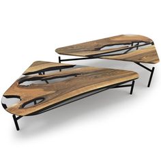 two wooden surfboards sitting on top of black metal legs, one is made out of wood and the other is shaped like a boat