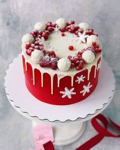 a red and white frosted cake sitting on top of a table