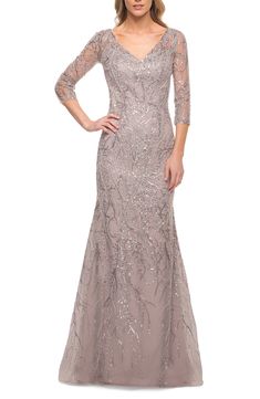 Shine at your next formal event in this stunning gown with shimmering beaded lace crafted in a classic V-neckline silhouette with a modified mermaid skirt. 60" length Hidden back-zip closure V-neck Three-quarter sleeves Lined 100% polyester Spot clean Imported Floor Length Lace Dress, Lace Long Gown, Trumpet Dress, Lace Mermaid, Dressy Dresses, Lace Dress Long, Mermaid Evening Dresses, Mermaid Gown, A Line Gown