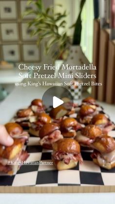 someone is placing mini sliders on a checkerboard board with the text cheesy fried mozzarella soft pretzel mini slides