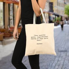 a woman is walking down the street carrying a tote bag that says, your favorite quote on it