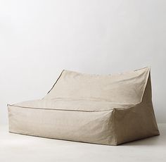 a beige couch sitting on top of a white floor