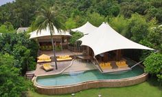 an aerial view of a resort with yellow lounge chairs