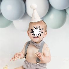 a baby wearing a party hat and suspenders is sitting in front of some balloons