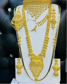 an elaborate gold necklace and earrings on display