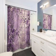 a purple shower curtain in a bathroom next to a white toilet and sink with blue walls